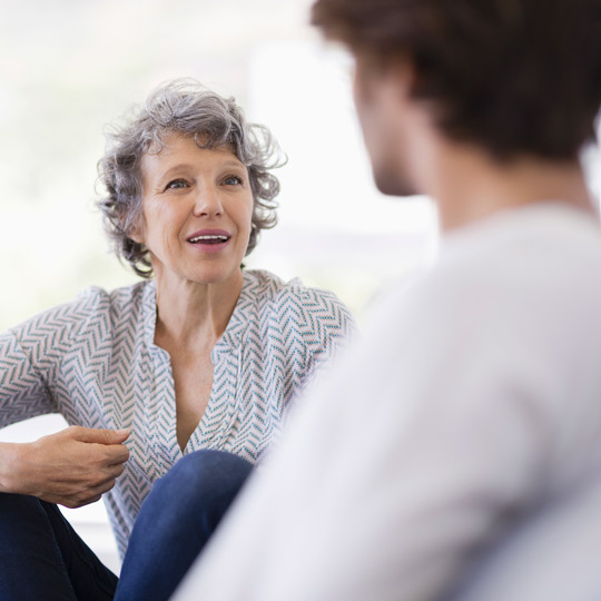 Older woman talking with someone.