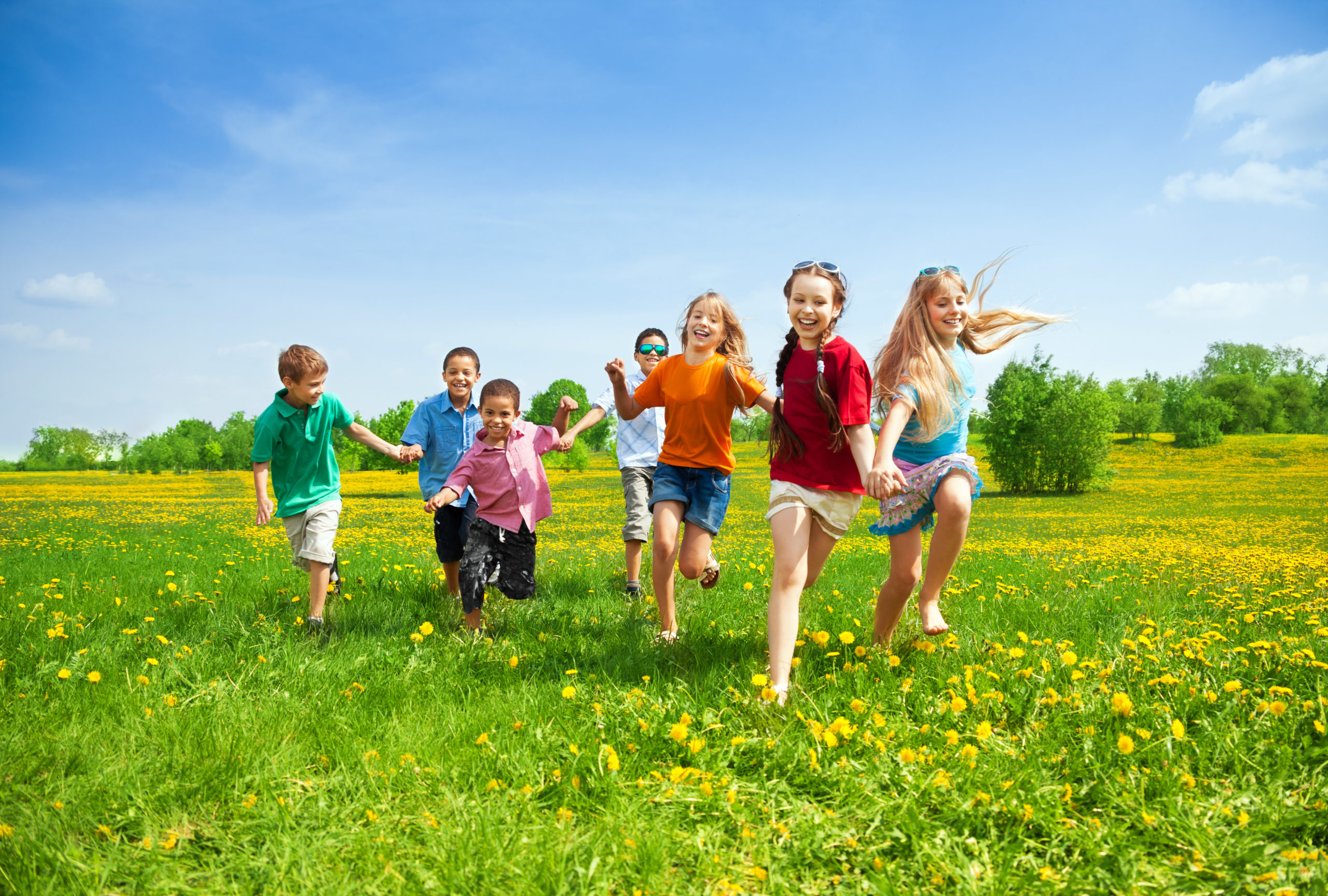Group of children running and playing during summer time.