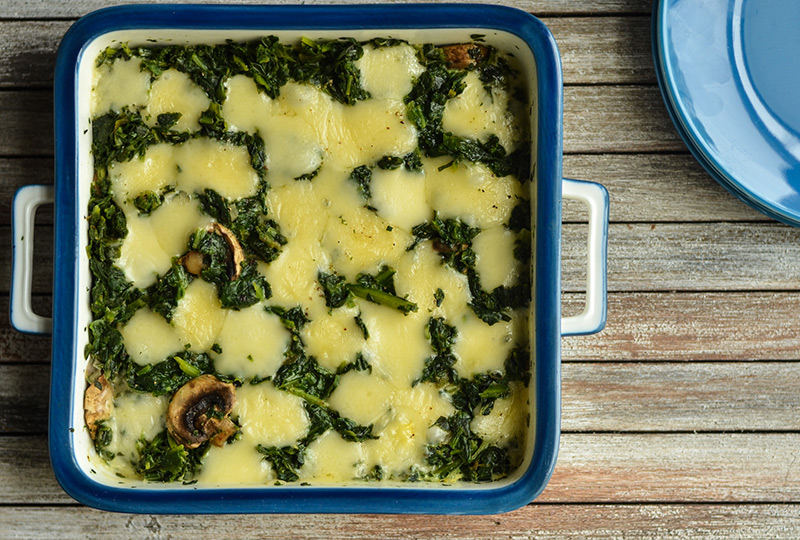 Square casserole pan containing spinach cheese quiche