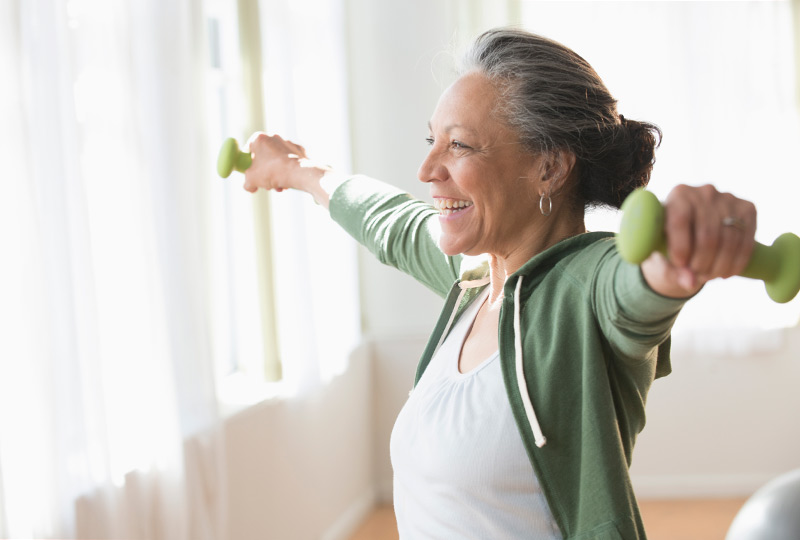 Older woman exercising with dumbbells