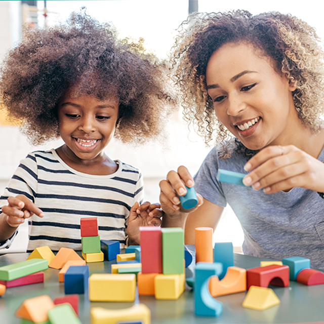 Mom and daughter play with blocks