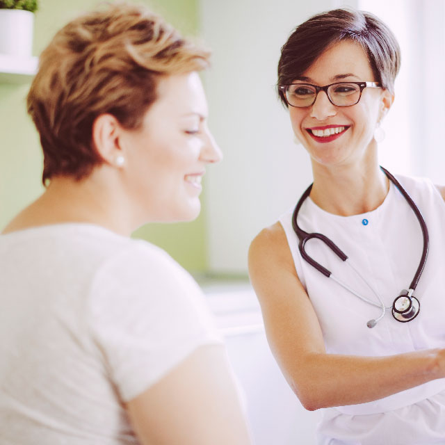 Doctor speaking to patient about mammography procedure.