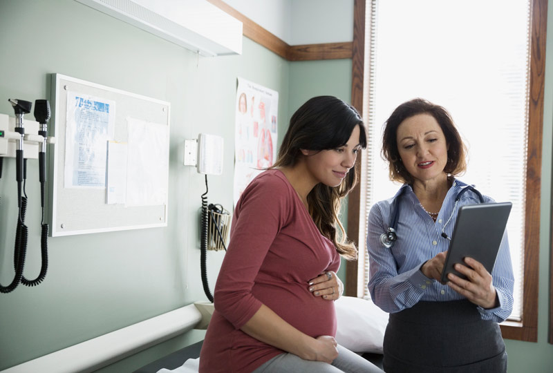 Pregnant woman talking with a healthcare provider.