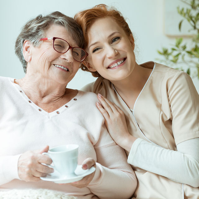 Daughter taking care of mother with Parkinson's disease.