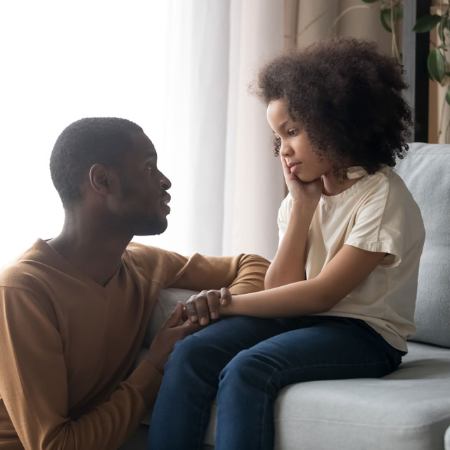 Father speaking to his anxious child.