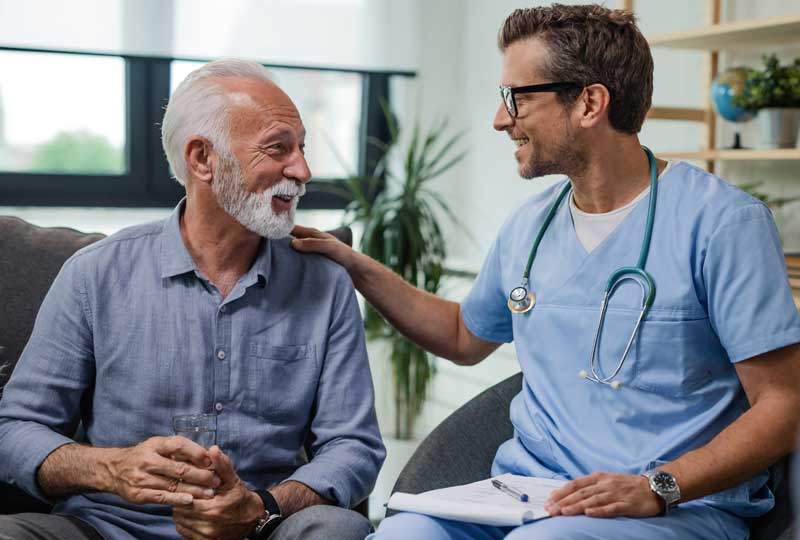Older man speaking to doctor about enlarged prostate care.