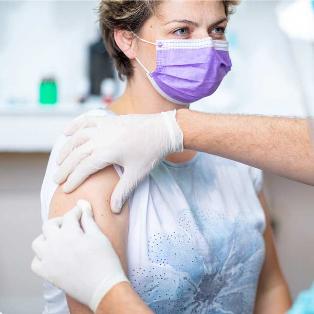 Women getting her arm wiped down for a flu shot