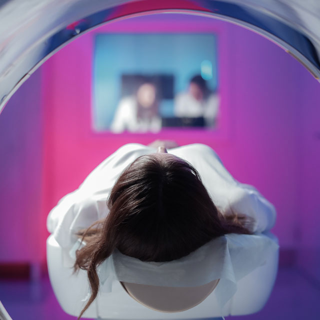 Patient in medical machine to scan brain