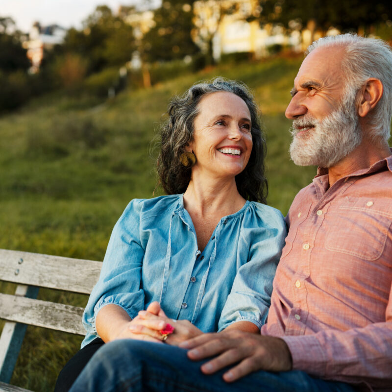 Man and woman on bench, smiling