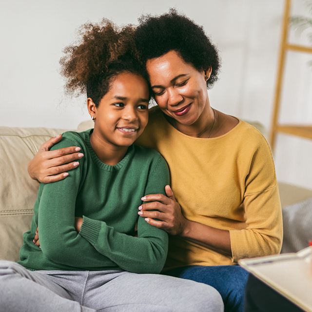 Mom hugging kid with therapist