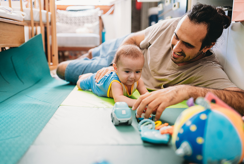 Father and infant, tummy time