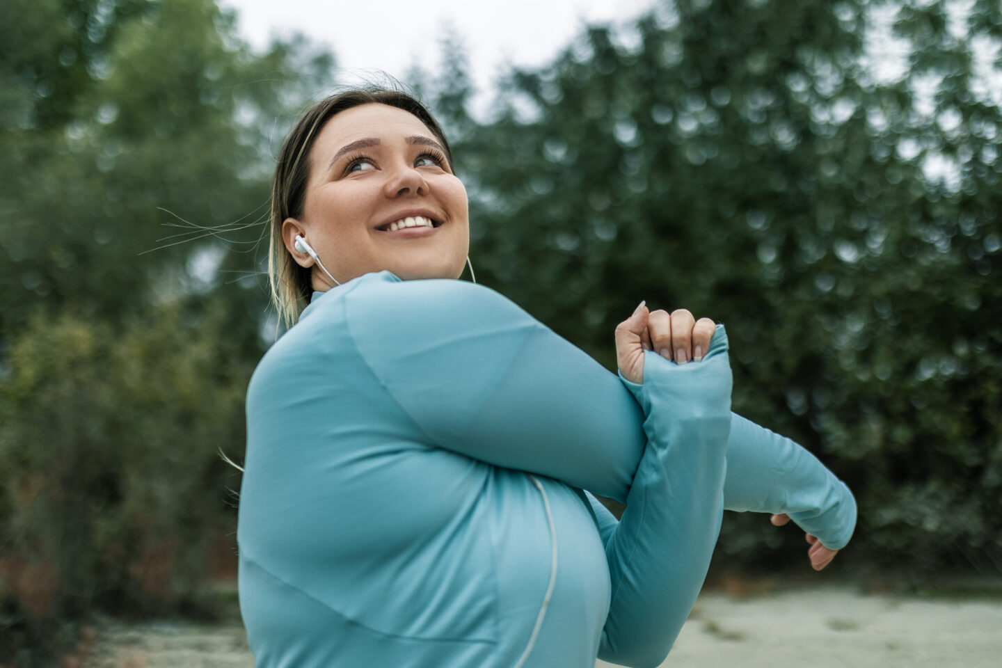 Young woman stretching by the river